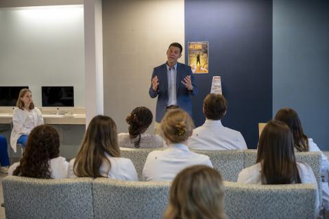 John Velis addresses a crowd of students.