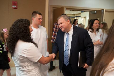 Steve Marcus shakes a student's hand.