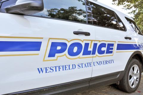 A close-up of a police cruiser, with "POLICE: Westfield State University" in blue text on its side.