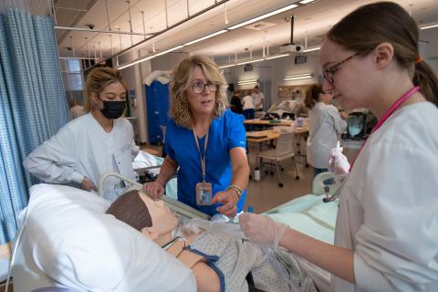 WSU Nursing faculty Jean Prast, works with students in the SIM lab