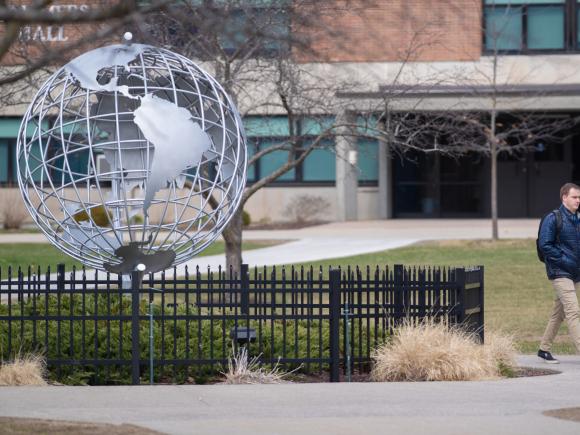 Student Walking past Globe