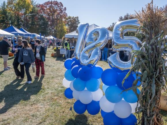 Blue balloons at this year's Homecoming tailgate that read "185", for 185 years of Westfield State.