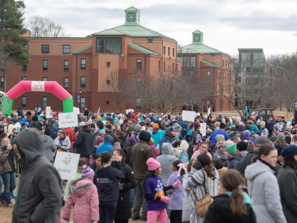 Girls on the Run, hosted on November 24. A crowd of people are gathered on the campus green for the 5K event.