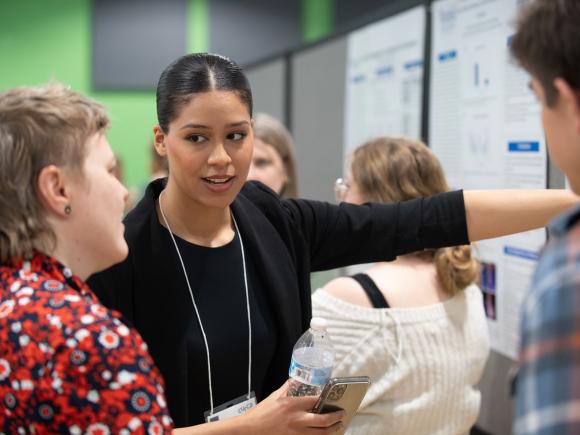 Biology student presenting their research at undergraduate research event.