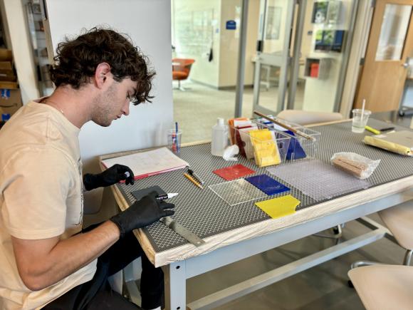 student working on fused glass project