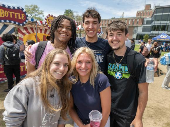 Group of students smiling together at Flight Fest event.