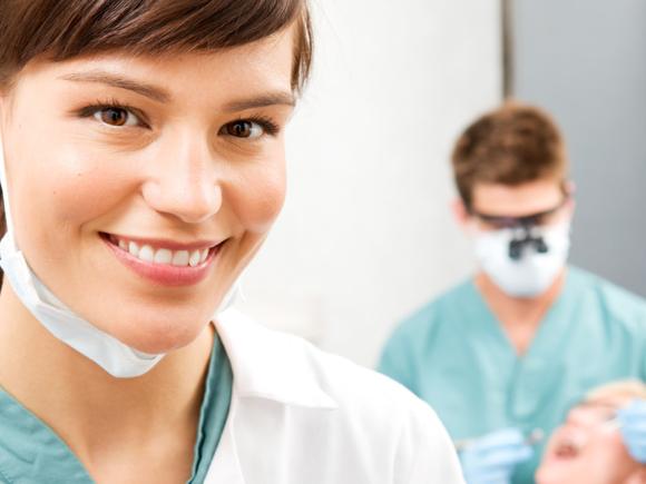 Dental Assistant with mask and med coat