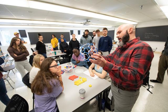 Alex Moore teaching students in a classroom