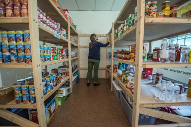 Interior of Common Goods showcasing pantry shelves with food.