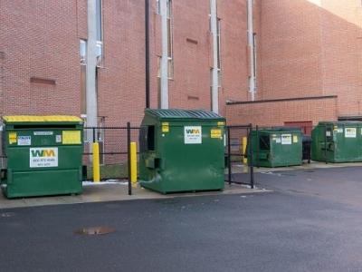 Two green waste management dumpsters on campus.