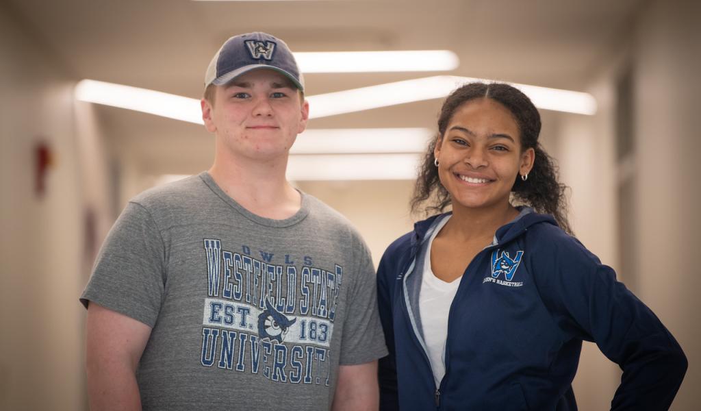 Two students smiling wearing WSU shirts.